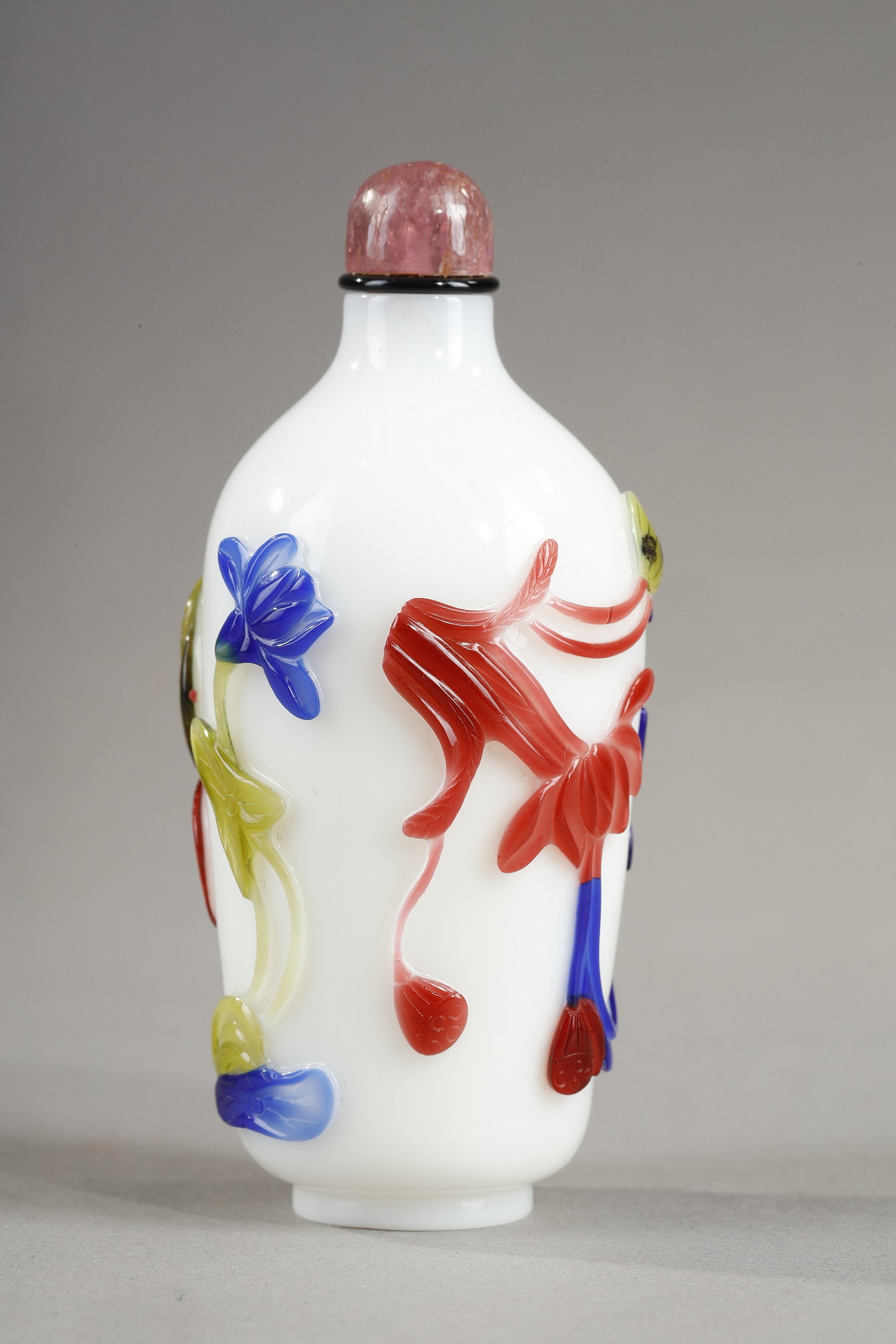 Cylindrical shaped snuff bottle in five colors on opaque white background decorated with flowers and bamboo stems China 1780/1850
